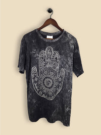 A black t-shirt featuring a print of a hamsa hand with geometric patterning