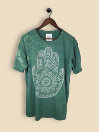 A green t-shirt featuring a print of a hamsa hand with geometric patterning