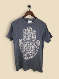 A grey t-shirt featuring a print of a hamsa hand with geometric patterning