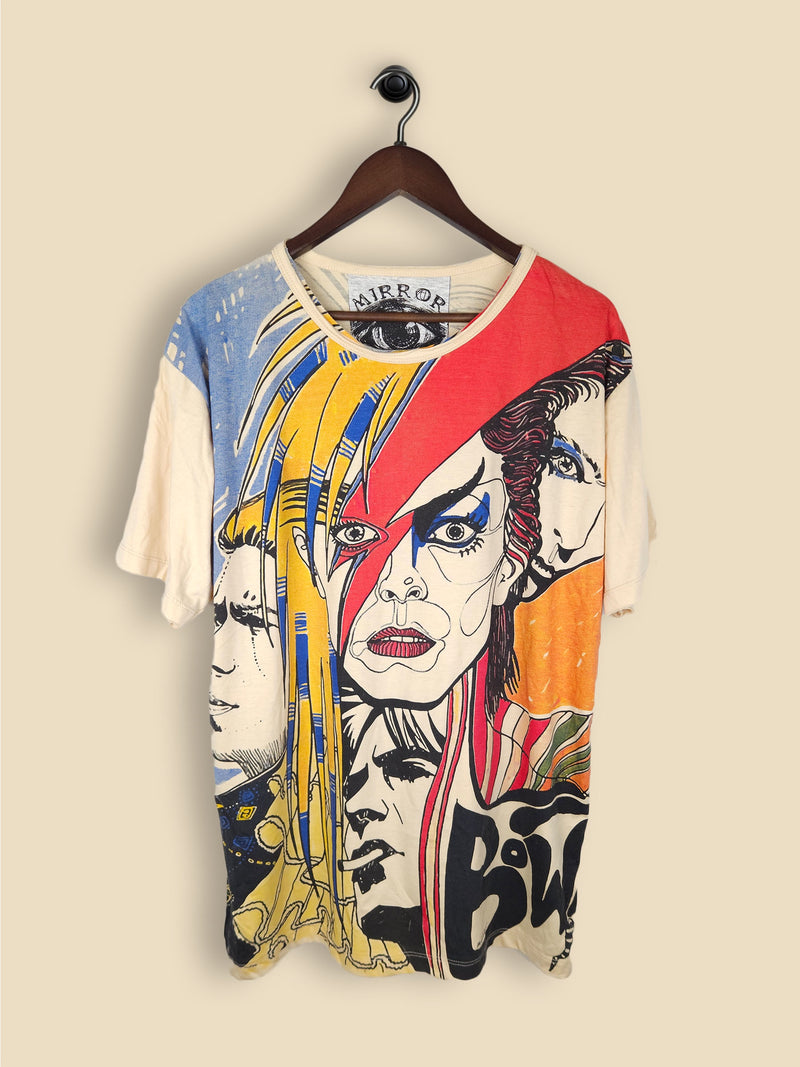 A beige T-shirt featuring artistic, colourful illustrations of David Bowie