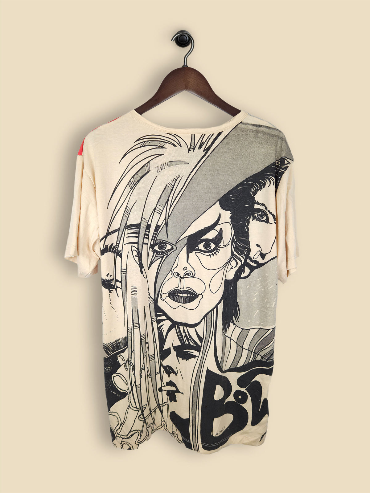 A beige T-shirt featuring artistic, colourful illustrations of David Bowie