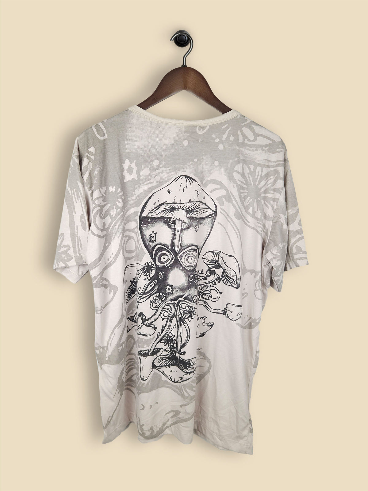 A light grey t-shirt featuring a bold design of an octopus, festooned with colorful mushrooms.
