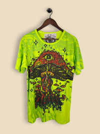 A green T-shirt featuring a colourful, psychedelic mushroom design with smaller mushrooms, vibrant colors and star-like shapes.