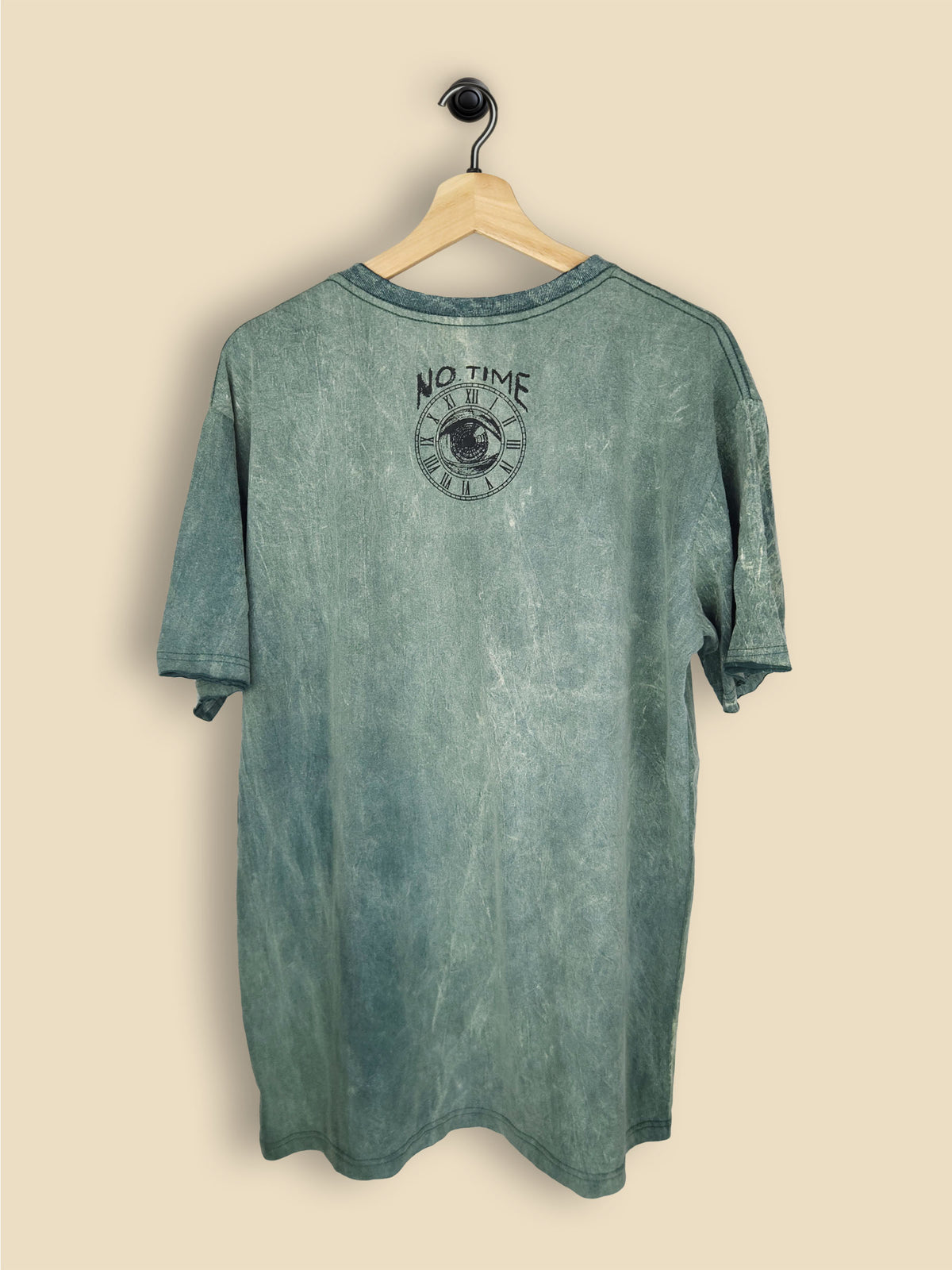 A sea green-coloured T-shirt with a stonewash, tie-dye effect. The front of the shirt features a vibrant graphic print of Albert Einstein, wearing sunglasses, a Hawaiian shirt, and a yellow lei. The background of the graphic includes a tropical beach scene with palm trees and ocean waves.