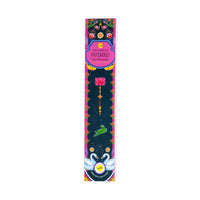 A colorful incense packaging with the label 'Indian Heritage Patchouli Herb Perfume Incense.' The design features a pink lotus flower, a green bird, and two white swans at the bottom. The background is dark with a pattern of small flowers and decorative elements.