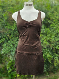 Brown mini dress on a mannequin against a green leafy background