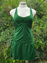 Green tank dress on a mannequin against a green leafy background