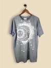 Slate Green T-shirt featuring a celestial design of a serene sun merging into a crescent moon with mandala details and star motifs