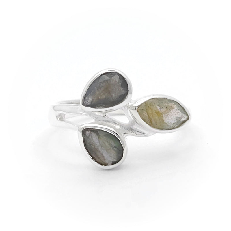 This image shows a silver ring with three teardrop-shaped stones arranged in a cluster. The stones have a rough, natural texture and vary in colour from dark grey to light greenish-grey. This ring is interesting due to its unique design and the natural appearance of the stones, making it a distinctive piece of jewellery.