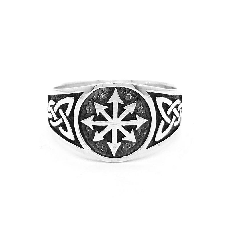 Metal ring featuring an intricately engraved eight-pointed star, framed by detailed Celtic knot patterns on either side. Textured background enhances contrast, highlighting the bold geometric design.
