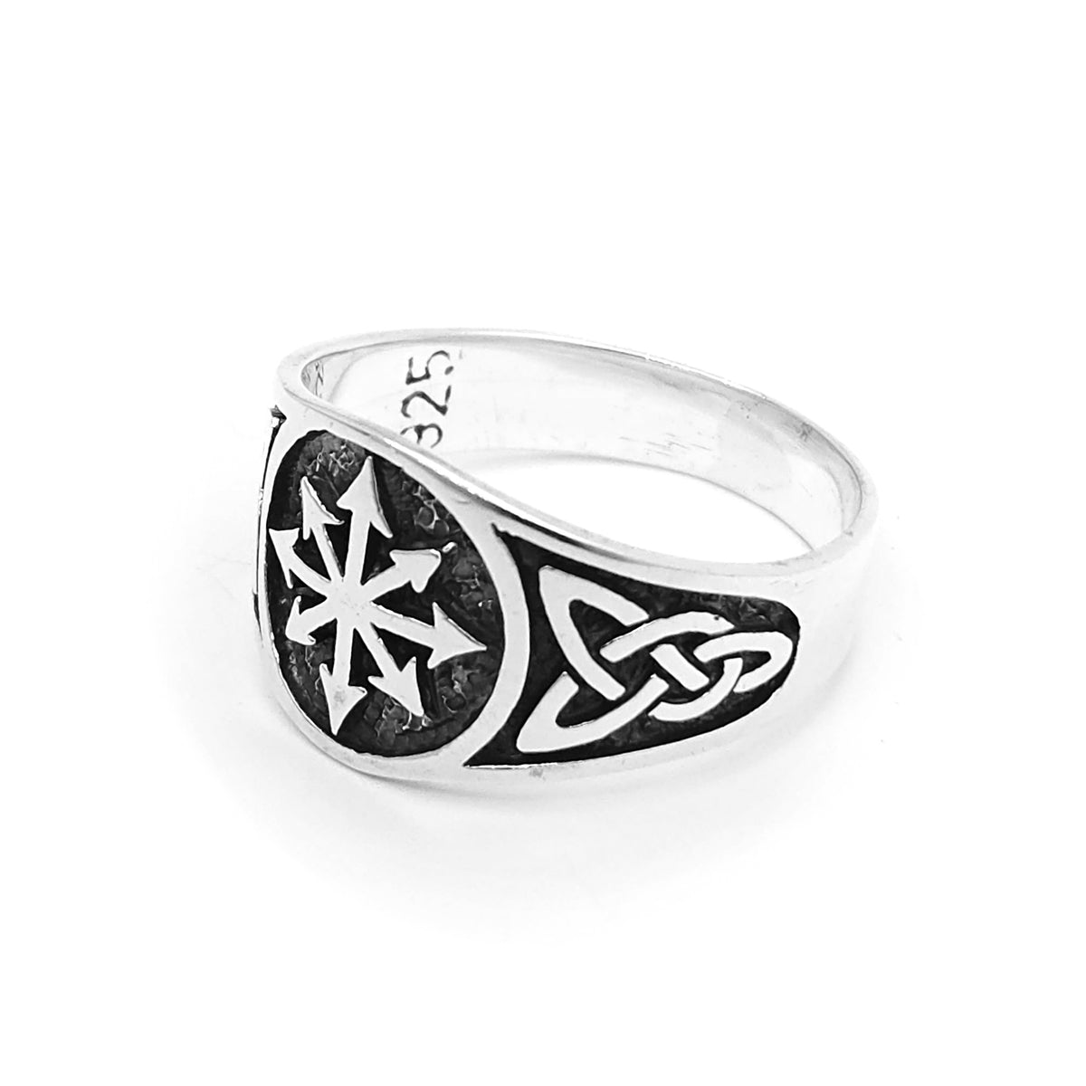 Metal ring featuring an intricately engraved eight-pointed star, framed by detailed Celtic knot patterns on either side. Textured background enhances contrast, highlighting the bold geometric design.