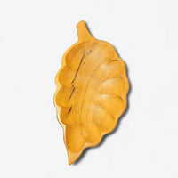 Wooden carved leaf on a white background