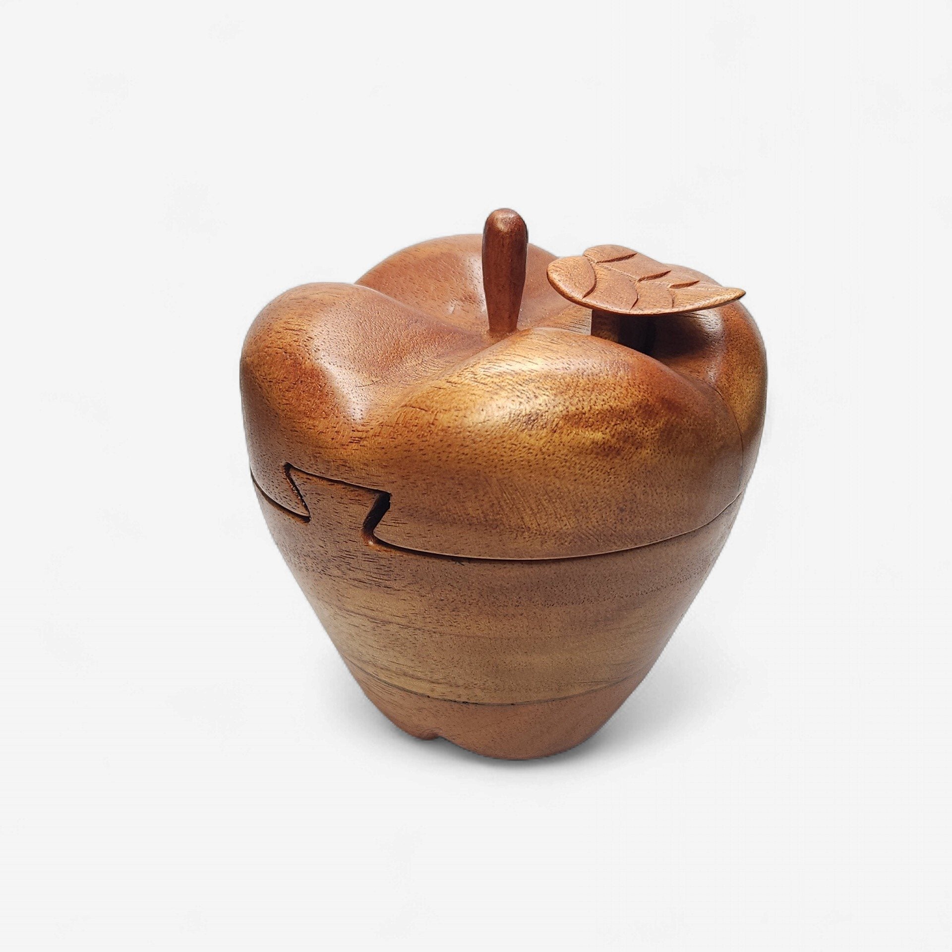 Wooden apple-shaped container with a lid on a white background