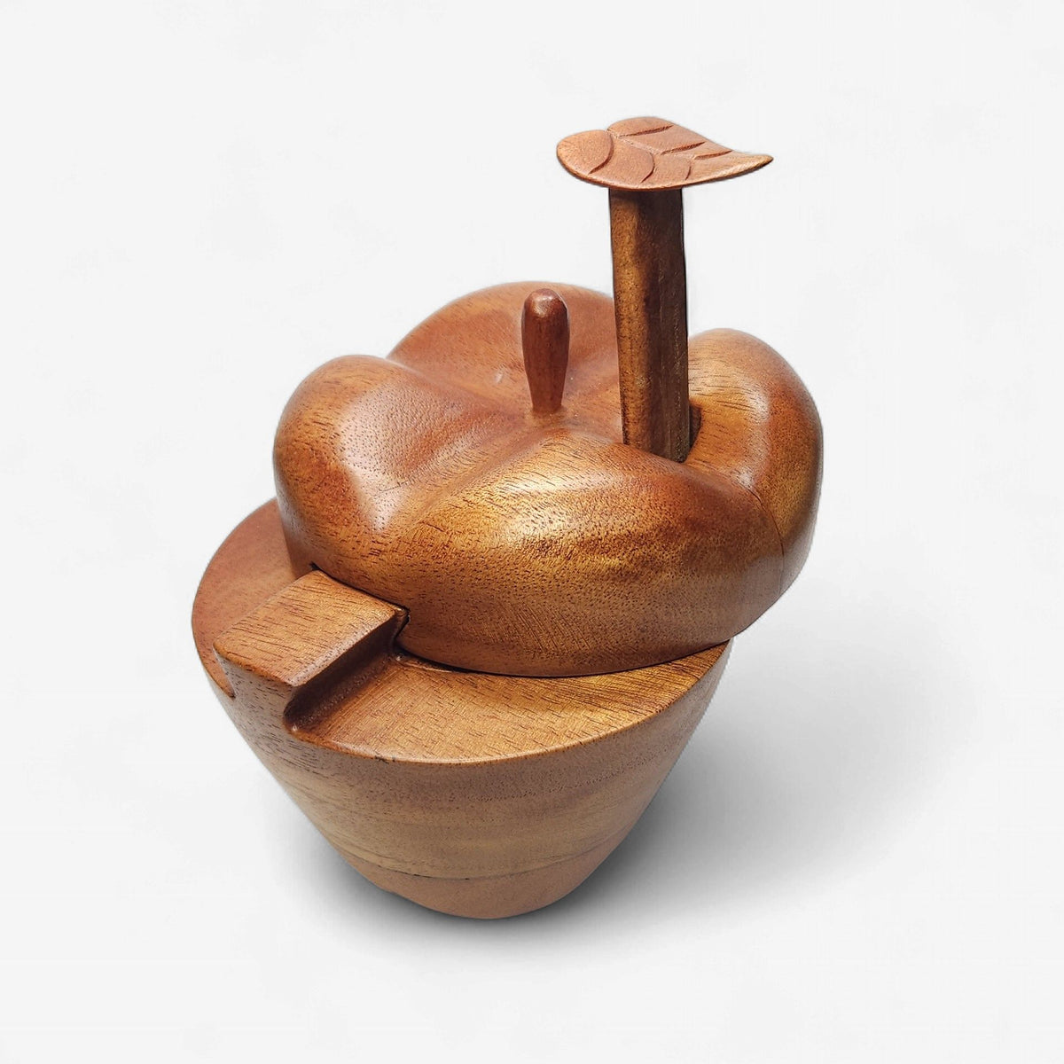 Wooden apple-shaped container with a lid on a white background