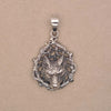 Front shot of sterling silver wolf face pendant in woodland surrounding